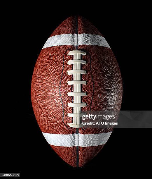 football on black - football americano stock pictures, royalty-free photos & images