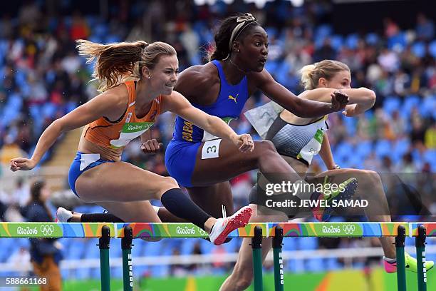 Netherlands' Nadine Visser, Barbados' Akela Jones, and Germany's Carolin Schafer compete in the Women's Heptathlon 100m Hurdles during the athletics...