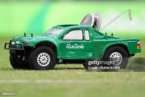 Remote control car carries discus in the Men's Discus Throw Qualifying Round during the athletics event at the Rio 2016 Olympic Games at the Olympic...