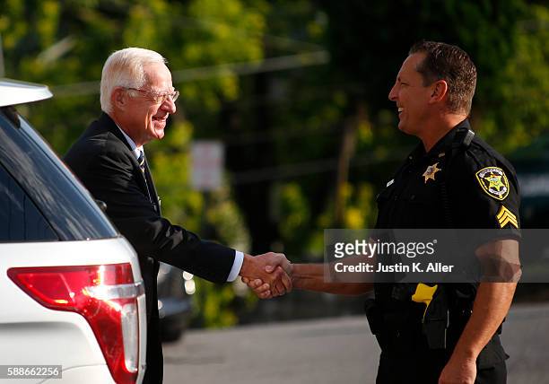 Judge John Cleland greets a police officer while entering the Centre County Courthouse to hear the appeal of Jerry Sandusky's child sex abuse...