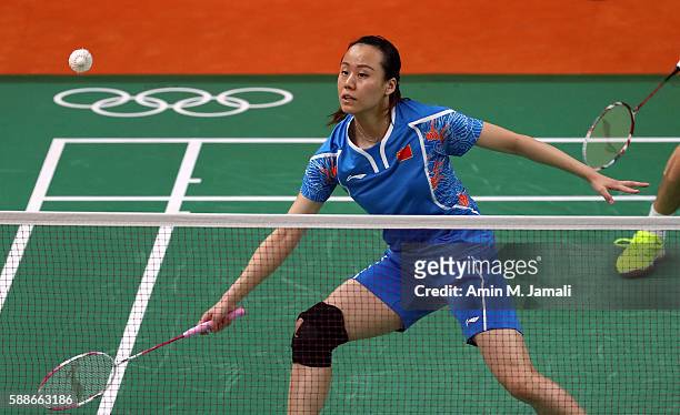 Jin Ma of China of China competes against Nadiezda Zieba and Robert Mateusiak of Poland in the badminton Mixed Double on Day 7 of the 2016 Rio...