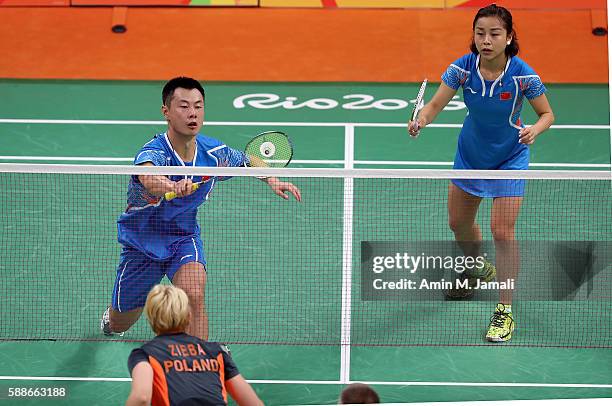 Chen Xu of China and Jin Ma of China competes against Nadiezda Zieba and Robert Mateusiak of Poland in the badminton Mixed Double on Day 7 of the...