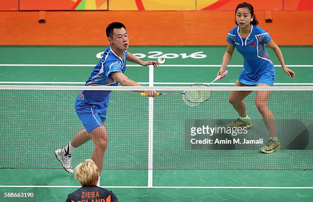 Chen Xu of China and Jin Ma of China competes against Nadiezda Zieba and Robert Mateusiak of Poland in the badminton Mixed Double on Day 7 of the...
