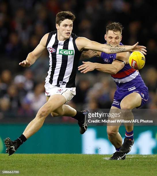 Jack Crisp of the Magpies and Clay Smith of the Bulldogs in action during the 2016 AFL Round 21 match between the Western Bulldogs and the...