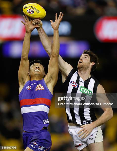 Lin Jong of the Bulldogs and Tyson Goldsack of the Magpies compete for the ball during the 2016 AFL Round 21 match between the Western Bulldogs and...