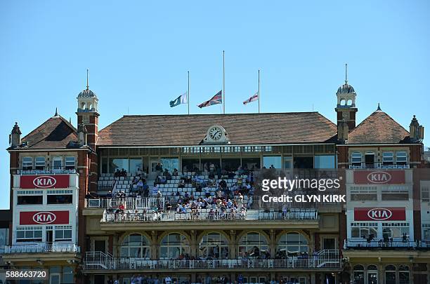 The English, British and Pakistani flags are pictured flying at half mast in memory of Pakistani cricketer Hanif Mohammad who died Thursday at the...