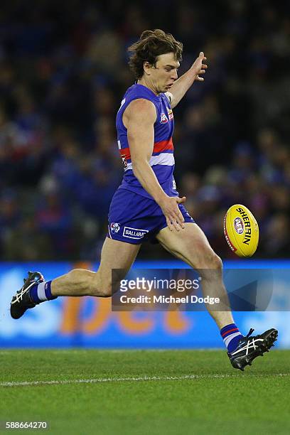 Liam Picken of the Bulldogs kicks the ball during the round 21 AFL match between the Western Bulldogs and the Collingwood Magpies at Etihad Stadium...