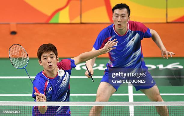 South Korea's Yoo Yeon Seong and South Korea's Lee Yong Dae serve to Taiwan's Sheng Mu Lee and Taiwan's Chia Hsin Tsai during their men's doubles...