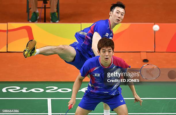 South Korea's Yoo Yeon Seong and South Korea's Lee Yong Dae serve to Taiwan's Sheng Mu Lee and Taiwan's Chia Hsin Tsai during their men's doubles...