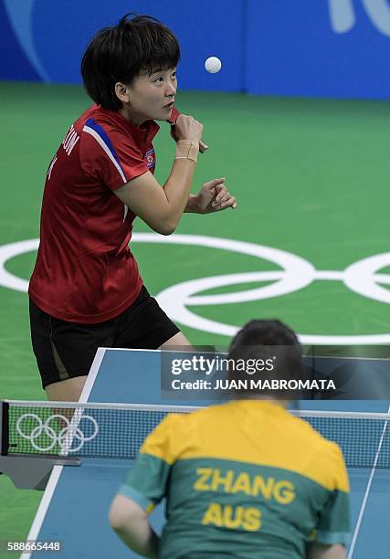 North Korea's Ri Myong Sun hits a shot next to teammate North Korea's Kim Song I in their women's team qualification round table tennis match against...