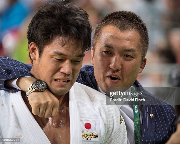 Japanese coach and 2004 Olympic gold medallist, Keiji Suzuki, consoles an emotional Ryunosuke Haga after he won the u100kg bronze medal during day 6...