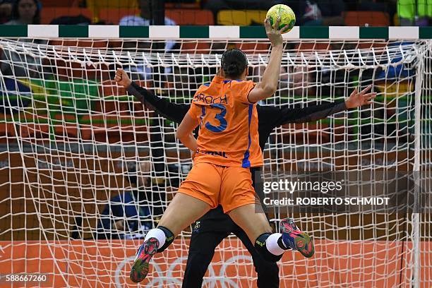 Netherlands' pivot Yvette Broch takes a 7-metre shoot out during the women's preliminaries Group B handball match Sweden vs Netherlands for the Rio...