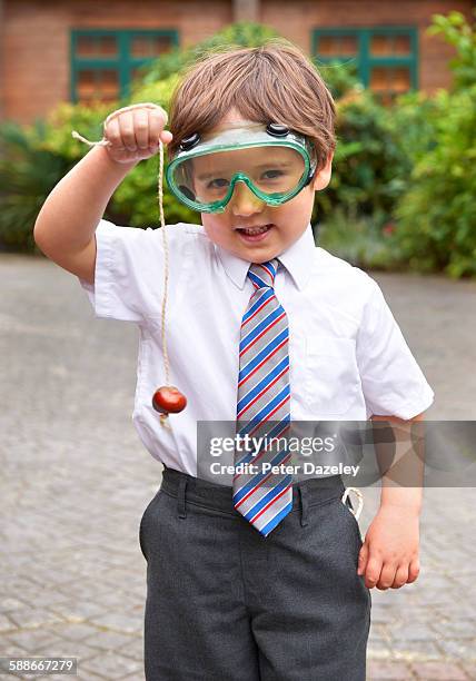 school boy playing conkers - horse chestnut stock pictures, royalty-free photos & images