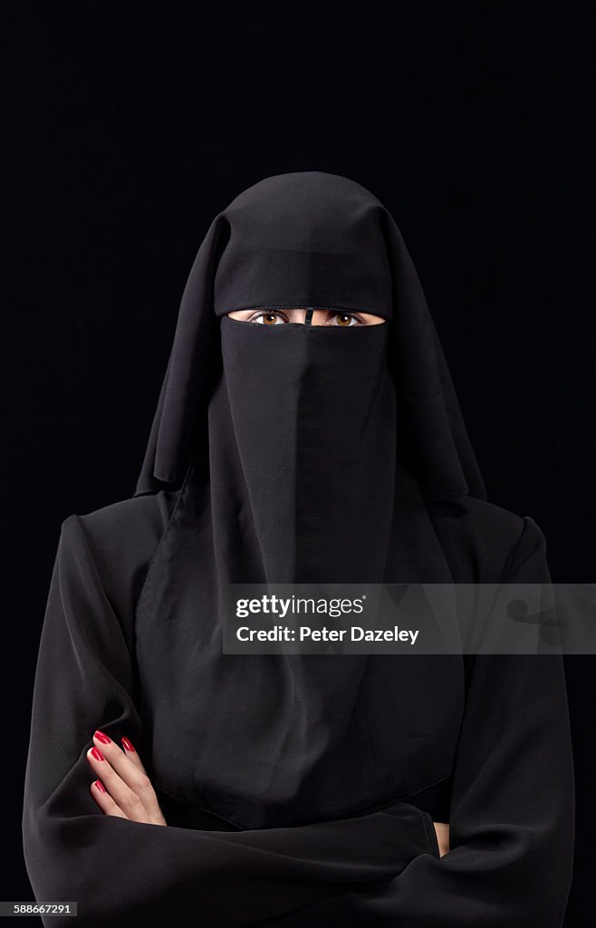 Woman in burka arms folded