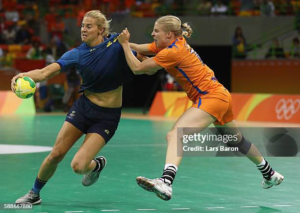 Isabelle Gullden of Sweden is challenged by Kelly Dulfer of Netherlands during the Womens Preliminary Group B match between Sweden and Netherlands on...