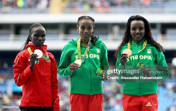Almaz Ayana of Ethiopia, gold medal, Vivian Jepkemoi Cheruiyot of Kenya, silver medal, and Tirunesh Dibaba of Ethiopia, bronze medal, pose on the...
