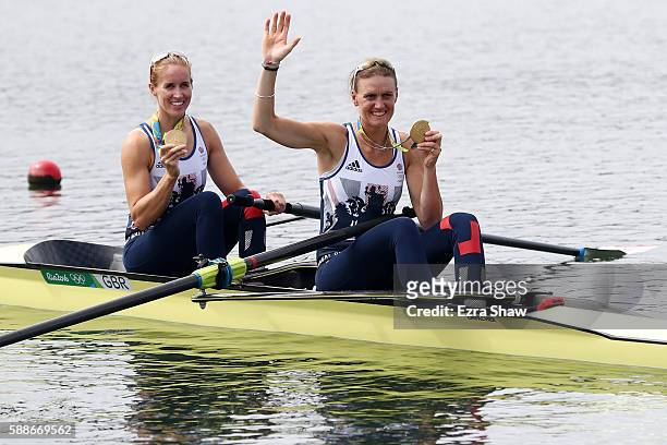 Gold medalists Helen Glover and Heather Stanning of Great Britain celebrate on their boat after the medal ceremony for the Women's Pair on Day 7 of...