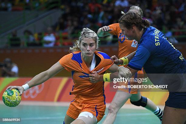 Netherlands' left back Estavana Polman vies with Sweden's centre back Carin Stromberg during the women's preliminaries Group B handball match Sweden...