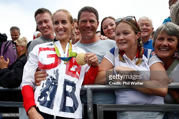 Gold medalists Helen Glover of Great Britain poses for photographs with Steve Backshall and her family to celebrate after the medal ceremony for the...