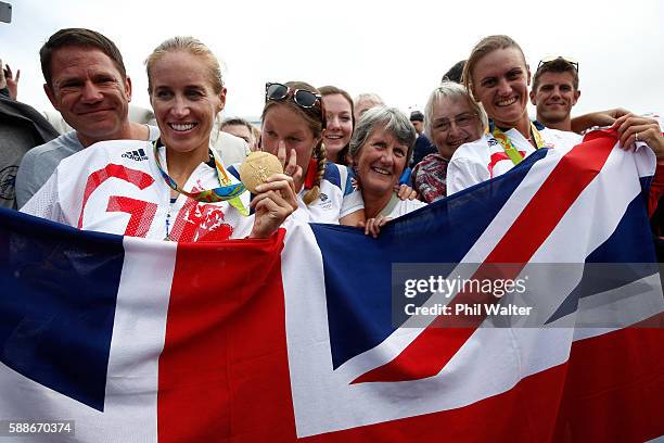 Gold medalists Helen Glover and Heather Stanning of Great Britain pose for photographs with Steve Backshall and their mothers after the medal...