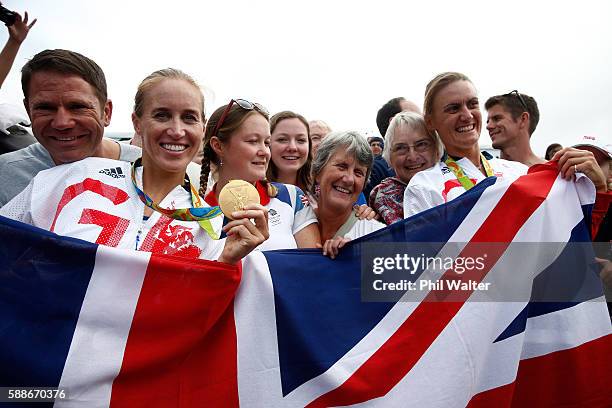 Gold medalists Helen Glover and Heather Stanning of Great Britain pose for photographs with Steve Backshall and their mothers after the medal...