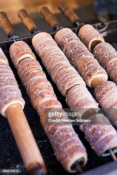 trdelník rolls on grill sticks - trdelník stock pictures, royalty-free photos & images