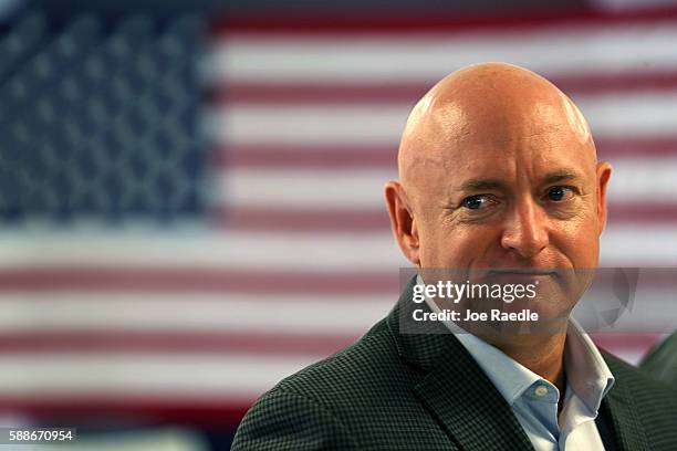 Retired NASA astronaut Mark Kelly waits to speak during a press conference where he joined his wife, former Rep. Gabrielle Giffords, and other...