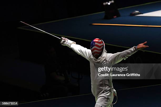 Miles Chamley-Watson of the United States celebrates against Timur Safin of Russia during a Men's Foil Team Semifinal bout on Day 7 of the Rio 2016...