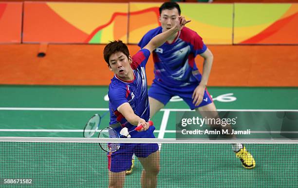 Yong Dae Lee and Yeon Seong Yoo of Republic of Korea competes against Sheng Mu Lee and Chia Hsin Tsai of Taipei in the badminton Men's Doubles Group...