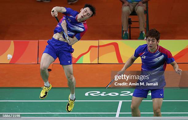 Yong Dae Lee and Yeon Seong Yoo of Republic of Korea competes against Sheng Mu Lee and Chia Hsin Tsai of Taipei in the badminton Men's Doubles Group...