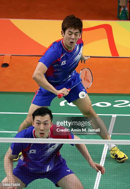 Yong Dae Lee and Yeon Seong Yoo of Republic of Korea competes against Sheng Mu Lee and Chia Hsin Tsai of Taipei in the badminton Men's Doubles Group...