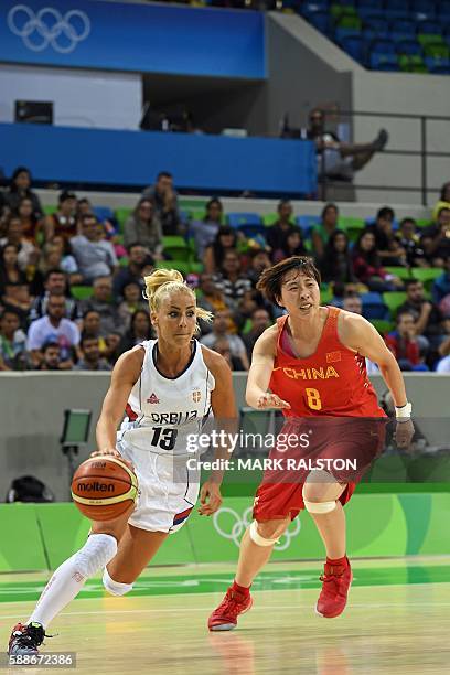 Serbia's point guard Milica Dabovic works around China's guard Wu Di during a Women's round Group B basketball match between Serbia and China at the...