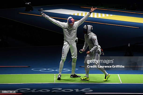 Miles Chamley-Watson of the United States celebrates against Timur Safin of Russia during a Men's Foil Team Semifinal bout on Day 7 of the Rio 2016...