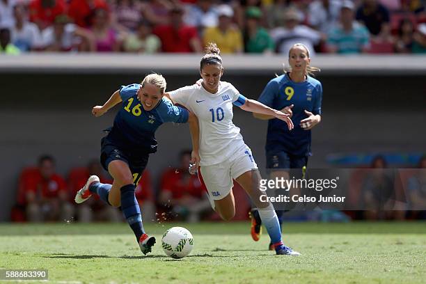 Carli Lloyd of United States battles for the ball against Elin Rubensson of Sweden in the first half during the Women's Football Quarterfinal match...