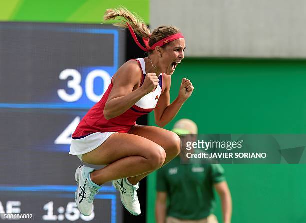 Puerto Rico's Monica Puig celebrates after winning her women's singles semi-finals tennis match against Czech Republic's Petra Kvitova at the Olympic...