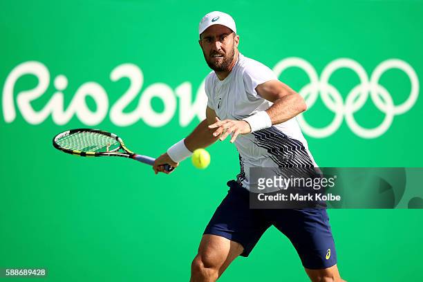 Steve Johnson of the United States returns a shot during against Andy Murray of Great Britain in the Men's Singles Quarterfinal on Day 7 of the Rio...