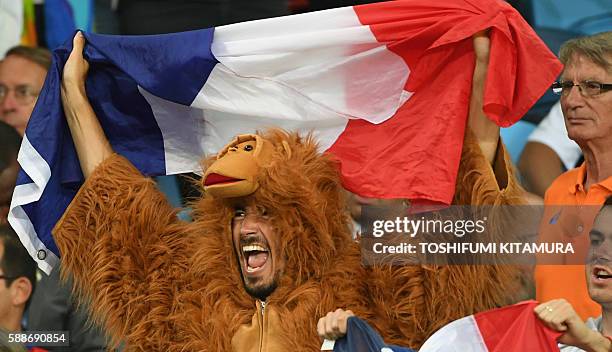 France supporter attends the final session of the women's +78kg and the men's +100kg judo contest at the Rio 2016 Olympic Games in Rio de Janeiro on...