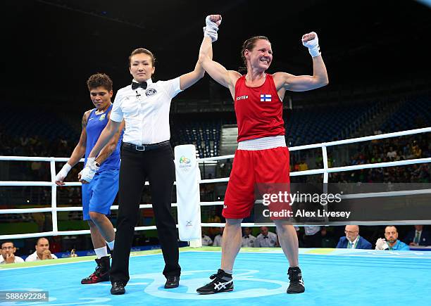 Mira Potkonen of Finland celebrates victory over Adriana Araujo of Brazil in the Women's Lightweight Preliminaries bout on Day 7 of the 2016 Rio...