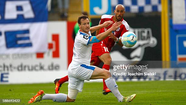 Tim Wendel of Lotte challenges Daniel Brueckner of Erfurt during the third league match between SF Lotte and Rot-Weiss Erfurt at Frimo Stadion on...