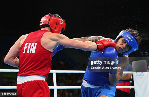 Mira Potkonen of Finland lands a right shot on Adriana Araujo of Brazil during the Women's Lightweight Preliminaries bout on Day 7 of the 2016 Rio...