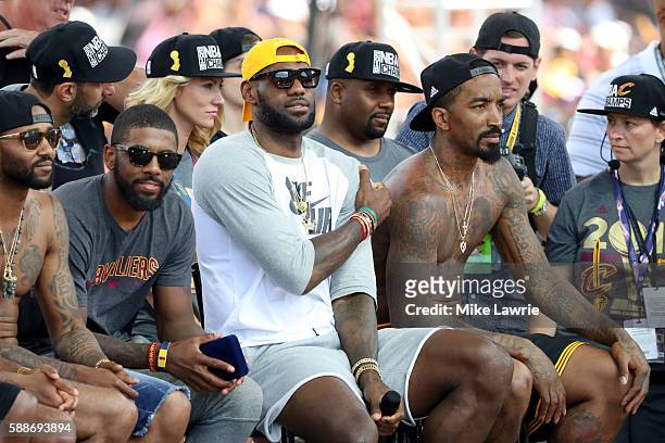 Kyrie Irving, LeBron James and J.R. Smith of the Cleveland Cavaliers look on during the Cleveland Cavaliers 2016 NBA Championship victory parade and...