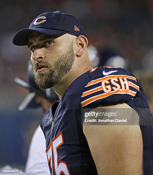 Kyle Long of the Chicago Bearswatches from the sidelines as teammates take on the Denver Broncos at Soldier Field on August 11, 2016 in Chicago,...