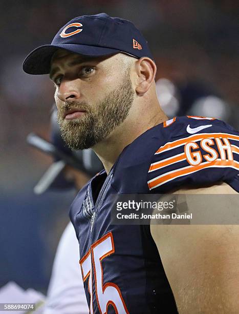 Kyle Long of the Chicago Bearswatches from the sidelines as teammates take on the Denver Broncos at Soldier Field on August 11, 2016 in Chicago,...