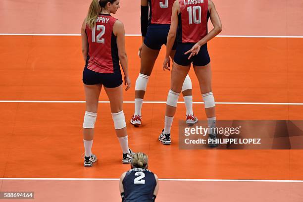 S Jordan Larson-Burbach gestures to her teammates during the women's qualifying volleyball match between the USA and Italy at the Maracanazinho...