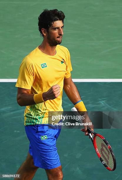 Thomaz Bellucci of Brazil celebrates winning the first set 6-2 against Rafael Nadal of Spain in the Men's Singles Quarterfinal on Day 7 of the Rio...