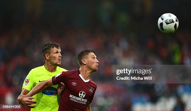 Mathias Wittek of Heidenheim and Jakub Sylvestr of Nuernberg compete for the ball during the Second Bundesliga match between 1. FC Nuernberg and 1....