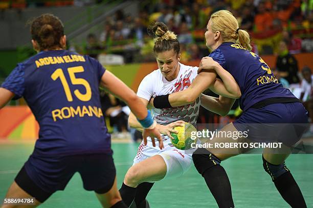 Spain's left back Nerea Pena Abaurrea vies with Romania's right back Gabriella Szucs during the women's preliminaries Group A handball match Romania...