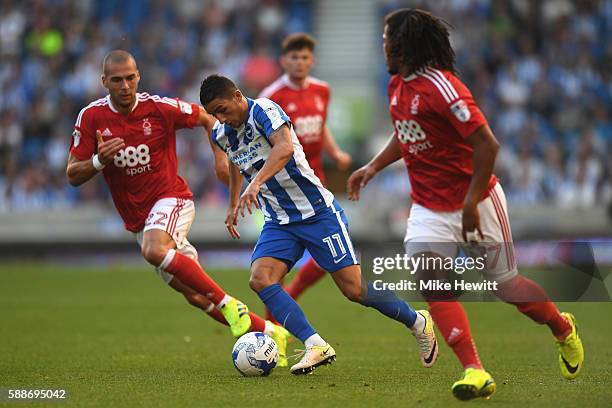 Anthony Knockaert of Brighton and Hove Albion skips past Pajtim Kasami and Hildeberto Pereira of Nottingham Forest during the Sky Bet Championship...