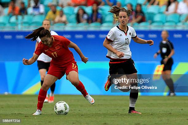 Yasha Gu of China is chased by Sara Dabritz of Germany during the Women's Football Quarterfinal match between China and Germany on Day 7 of the Rio...