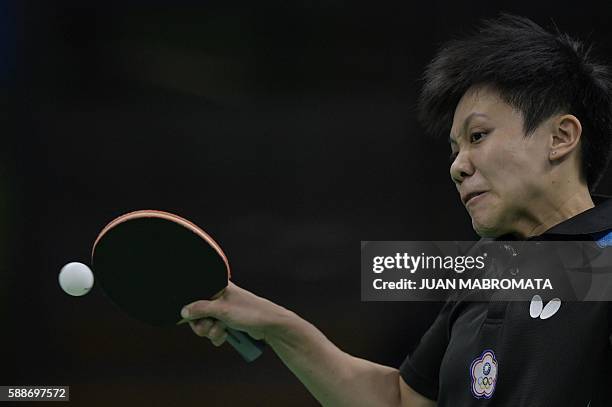 Taiwan's Cheng I-Ching hits a shot in the women's team qualification round table tennis match against Hong Kong's Lee Ho Ching at the Riocentro venue...